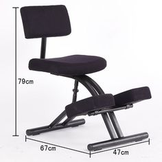 a black office chair sitting on top of a white floor next to a height chart