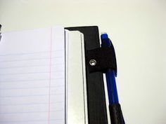 an open notebook and pen sitting on top of a desk