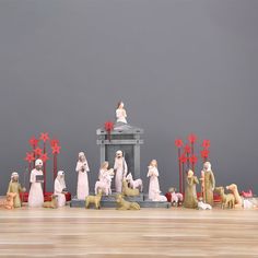 a group of figurines sitting on top of a wooden floor next to each other