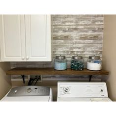 a washer and dryer sitting next to each other in front of a wall