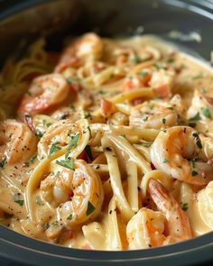 pasta with shrimp and sauce in a crock pot, ready to be eaten for lunch