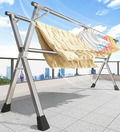 a clothes line on top of a roof in front of a cityscape with skyscrapers