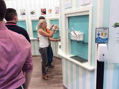 two people are standing in front of a water dispenser that is on display