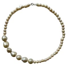 A beautiful and very modern way to wear pearls. This necklace is made of two different types of freshwater pearls. Cream white baroque pearls with an average diameter of 12mm - 14mm and cream white freshwater pearls with an 8mm diameter. The closure is 925 Sterling silver. This necklace is so versatile- it combines a classic yet contemporary style. It looks great on t-shirt and leather jacket, blouse for business or any kind of dress for going out. The big baroque pearls are a showstopper and ad Luxury White Necklaces With Colorful Beads, Pink Topaz Necklace, Beautiful Beaded Necklaces, Jacket Blouse, Wear Pearls, Ruby Beads, Topaz Necklace, Pink Topaz, Freshwater Pearl Necklace