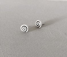 Small spiral stud earrings made of silver 925. Spiral is one of the oldest symbols used by mankind. It appears ever since the Paleolithic era in Greece. This complicated but so powerful symbol is to be found everywhere in many ancient civilizations all around the world as well, as a symbol of the living force.Above all and especially in Greece it has always been a sign and a symbol of the Ancient Greek spirit and the Ancient Greek living force. It declares as a historic symbol the Greek origin o Diy Earrings Studs, Hip Jewelry, Paleolithic Era, Spiral Jewelry, Earrings Cool, Cool Earrings, Silver Choker Necklace, Rose Quartz Earrings, Swirl Earrings