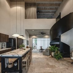 an open kitchen and living room area in a modern style house with wood floors, white walls and ceilings