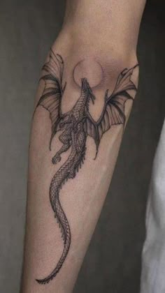 a man with a dragon tattoo on his arm