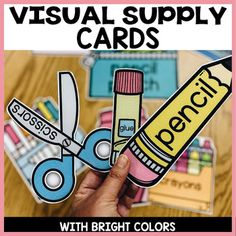 a person holding up a pair of scissors and a pencil with the words visual supply cards