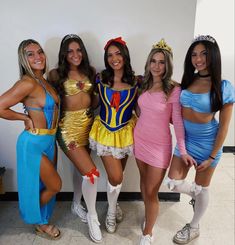 four women dressed in costumes posing for the camera