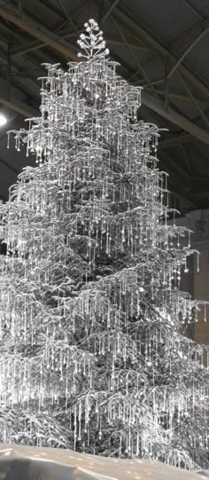 a large metal christmas tree sitting inside of a building