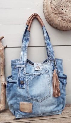 a denim purse sitting on top of a wooden bench