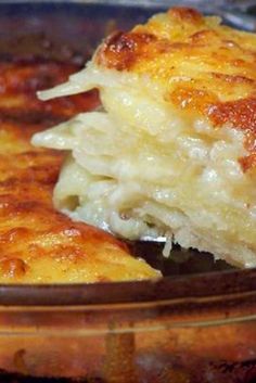 a casserole dish with cheese and onions in a brown bowl on a table