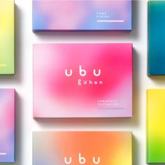 four different colored business cards with the word ubu on them