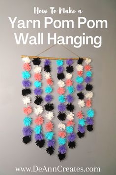 yarn pom - pom wall hanging with the words how to make a yarn pom