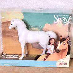 a toy horse and its box sitting on a table