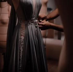 a woman in a dress is being worked on