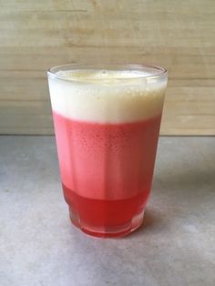 a red and white drink sitting on top of a counter