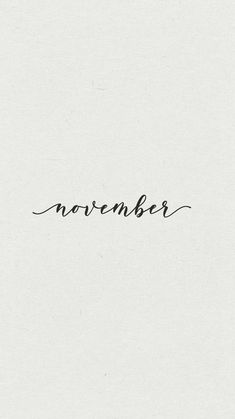 the word november written in cursive ink on a white paper with black writing