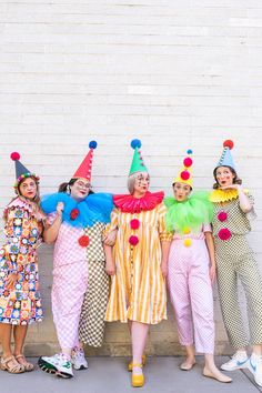 four women in clown costumes posing for a photo