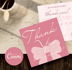 two thank you cards with pink bows on them next to a cup and vase filled with flowers