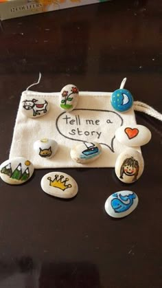 some buttons are sitting on top of a black table with a white bag and other items