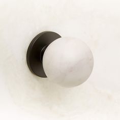 a white marble door knob with black trim