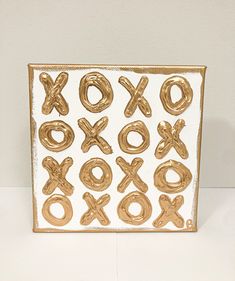 an image of a gold xoxo sign on a white table top with the letter xo spelled out