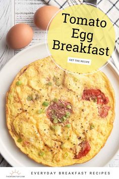 a white plate topped with an omelet next to eggs