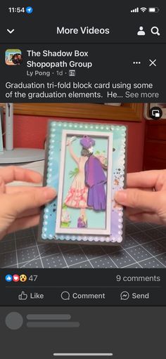 someone is holding up a card with an image of a woman in a dress on it