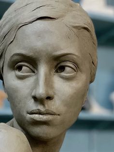 a close up of a statue of a woman's head