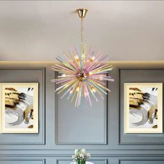 a dining room table with chairs and a chandelier hanging from the ceiling