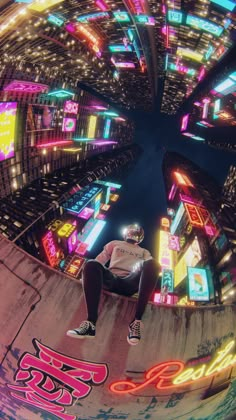 a man sitting on top of a skateboard next to neon lights