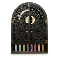 an ornate iron door with the moon and stars painted on it