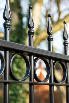 a black metal fence with circles on it