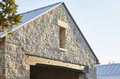 an old brick building with a metal roof