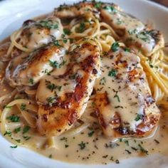 chicken with sauce and noodles on a white plate