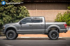 a gray truck parked in front of a building