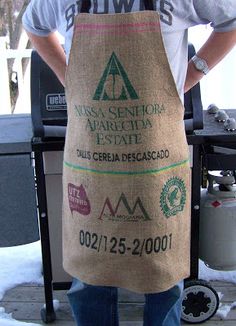 a man standing in front of a bbq grill with a bag on his back