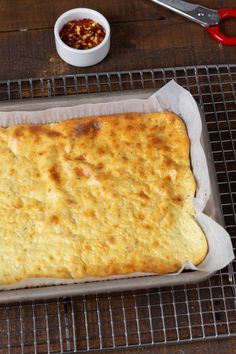 an omelet sitting on top of a pan next to a bowl of chili