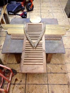 a wooden bench sitting on top of a tile floor