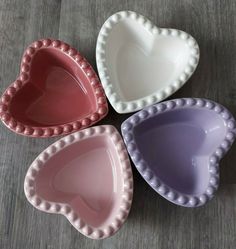 three heart shaped dishes sitting on top of a table