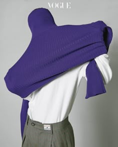 a woman's purple sweater with a white shirt underneath it