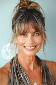 Save this pin for the best hairstyles for women over 60 with bangs. Rock a carefree vibe with this messy bun, featuring face-framing bangs and streaks of sun-kissed highlights. The bangs frame and soften the facial features. Hair Curtains, Bob With Wispy Bangs, Longer Bob, Bun With Bangs, Curtains Bangs, Hairstyles Brown, Haircut Brunette, Haircut Balayage, Blond Hairstyles