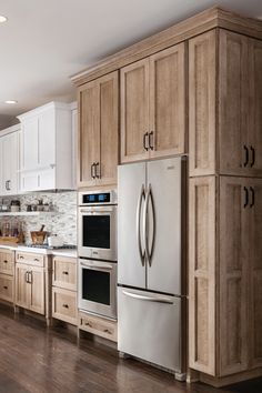 a kitchen with wooden cabinets and stainless steel appliances