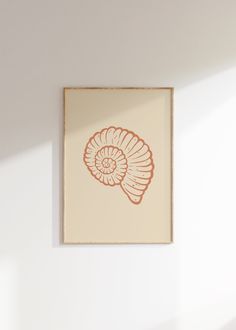 an orange shell print hangs on the wall