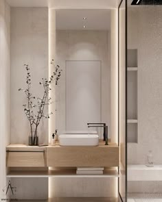 a bathroom with a sink, mirror and vase on the counter in front of it