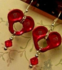 two red heart shaped earrings with silver beads