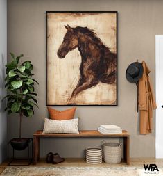 a brown horse painting hanging on the wall next to a wooden bench and coat rack