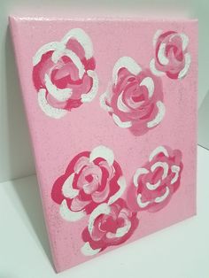 pink and white painted canvas with flowers on it