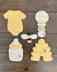 some cookies that are on top of a wooden table and one has a baby's bib